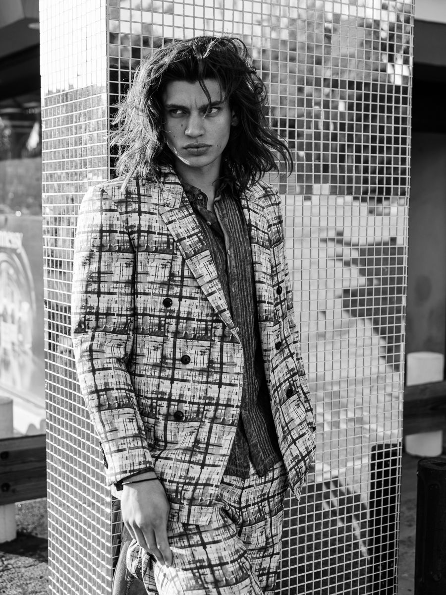 Strange Memories for JÓN Magazine: a painterly checked suit worn open against a mirrored mosaic column, styled by Quentin Fears
