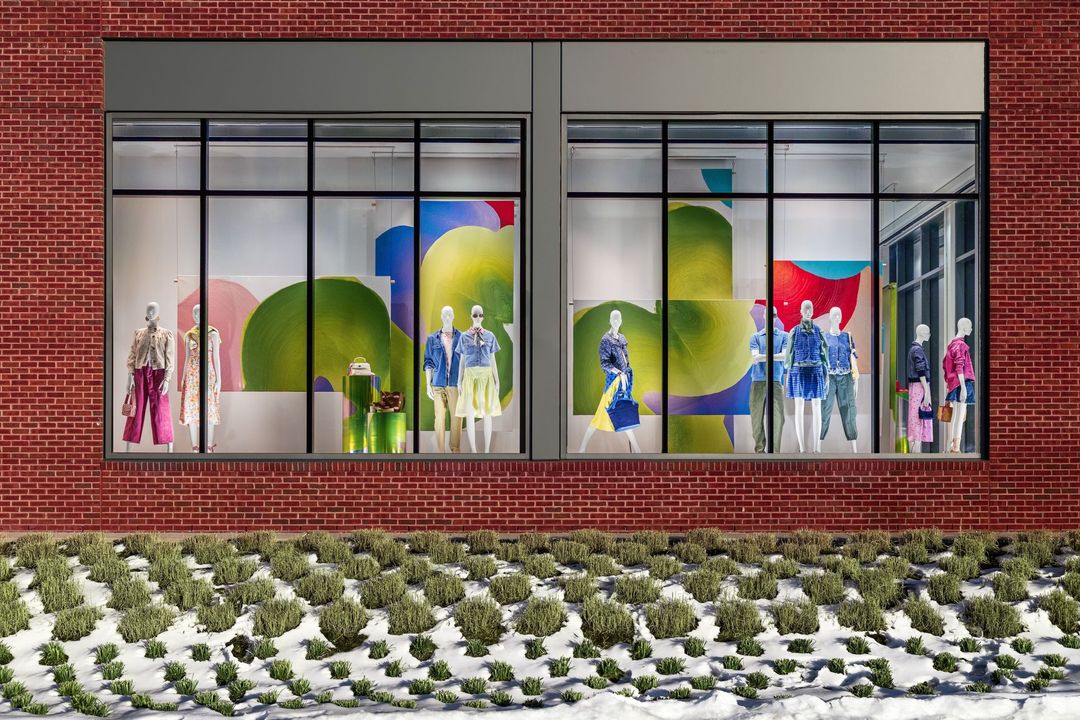 Spring Awakening at Walmart's Fashion Statement Windows in Bentonville: two window bays of spring looks in front of artist Muoi Le's large painted canvases
